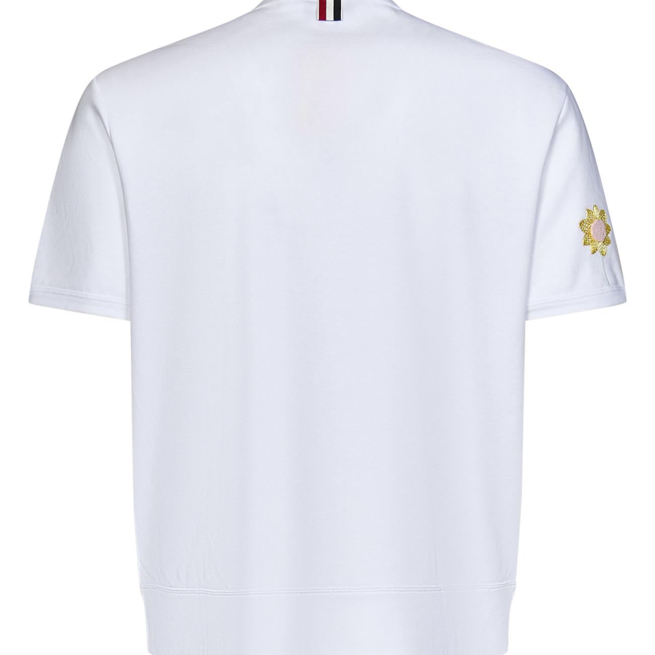 White cotton jersey T-shirt with flowers embroidered at front and at sleeve.