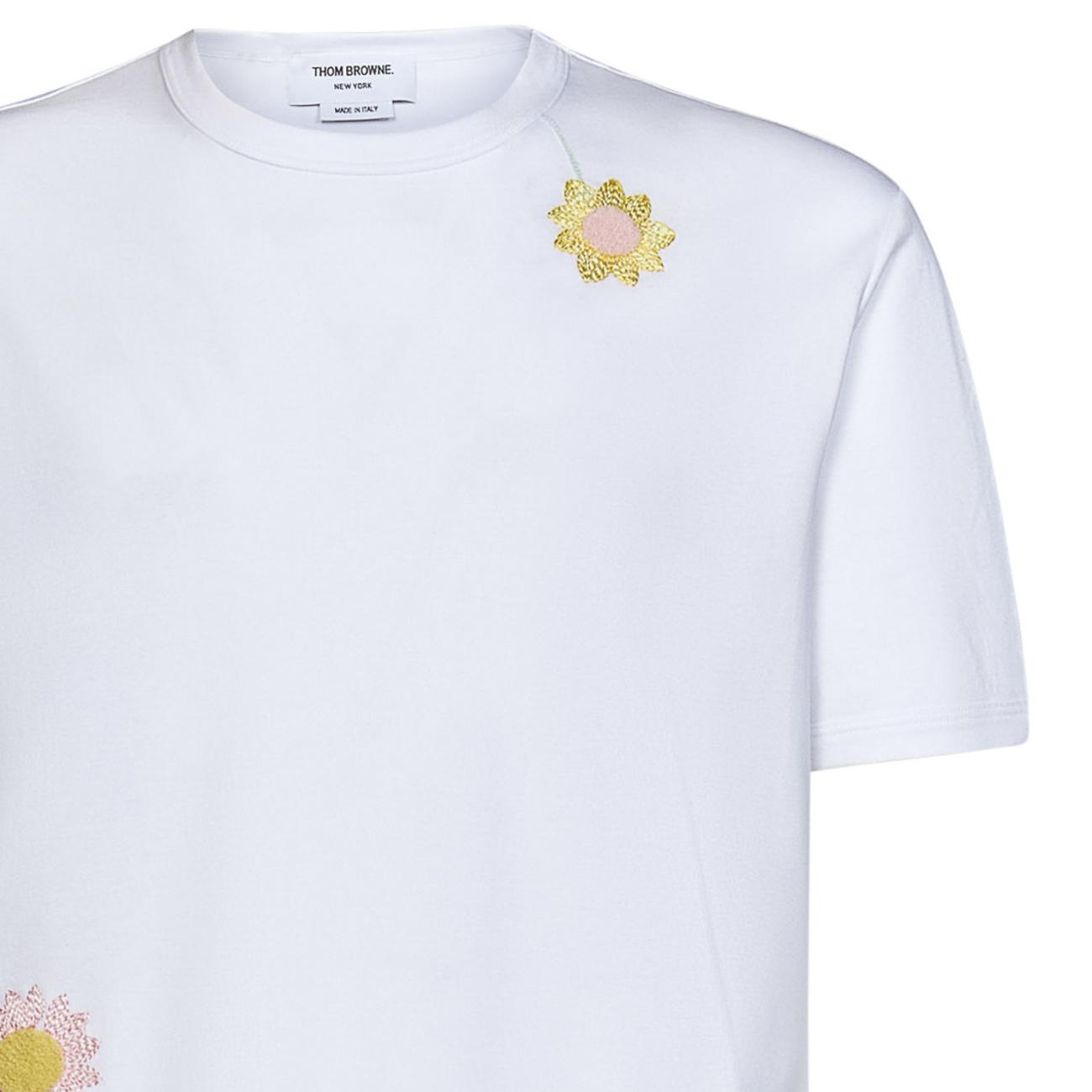 White cotton jersey T-shirt with flowers embroidered at front and at sleeve.