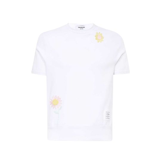 White cotton jersey T-shirt with flowers embroidered at front and at sleeve.